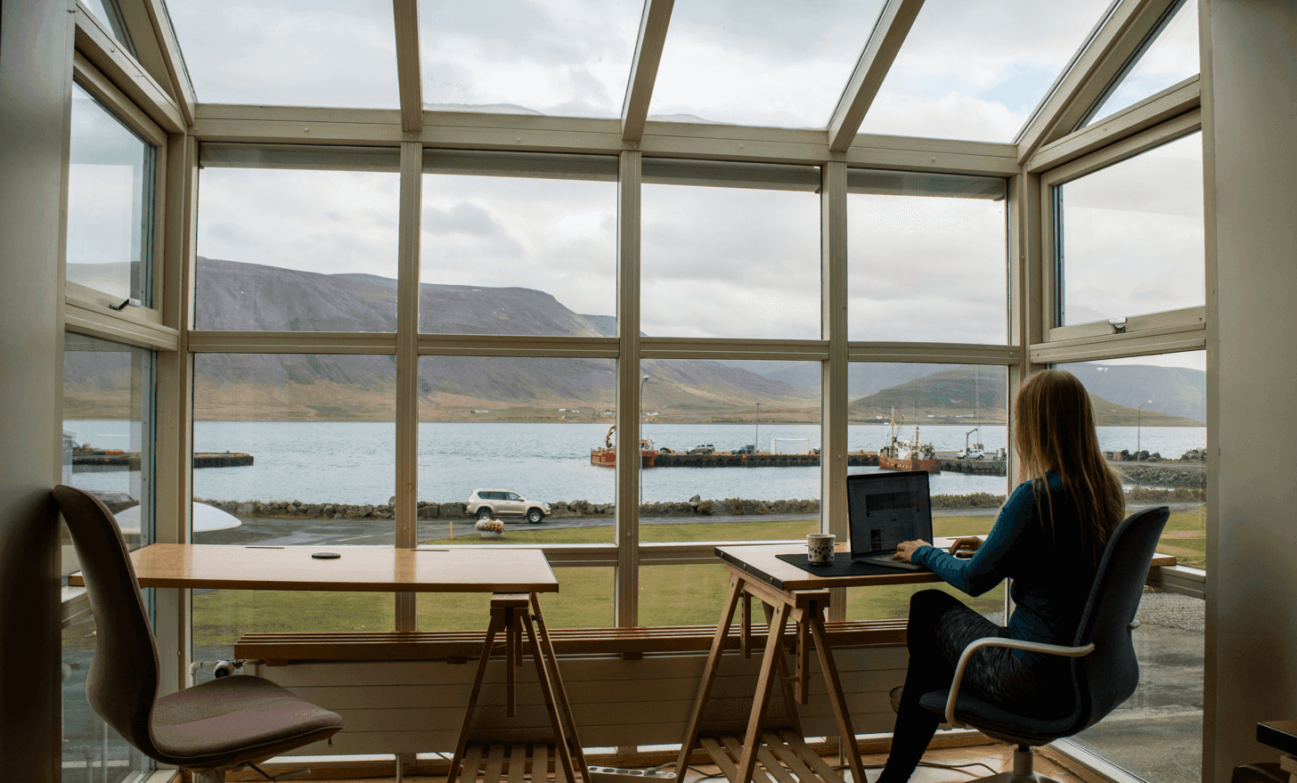 Online I-9 notarization - Professional notary at desk with scenic water and hills view performing remote I-9 verification